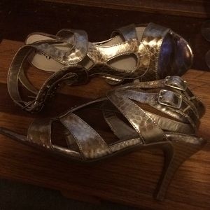 Gold strapped heeled dress sandal.